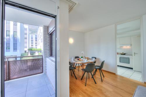 a kitchen and dining room with a table and a window at Casa Al Molo - Happy Rentals in Locarno