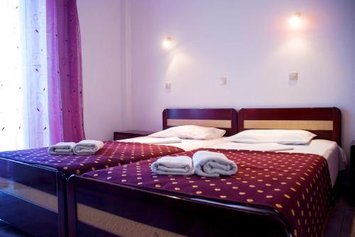 a bedroom with two beds with towels on them at Villa Agnanti Boutique in Grammatiko