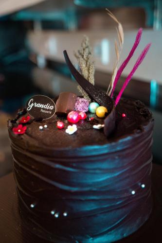 a chocolate cake sitting on top of a table at Grandia Hotel in Bandung