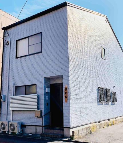 a gray building with a door and a window at HOSTEL UKS - Vacation STAY 13007 in Nagoya