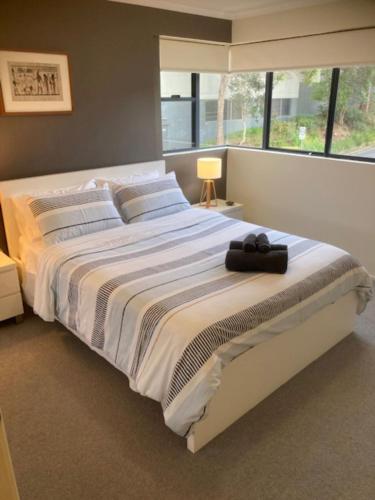 a large bed in a bedroom with a large window at Oceanview4 in Nambucca Heads