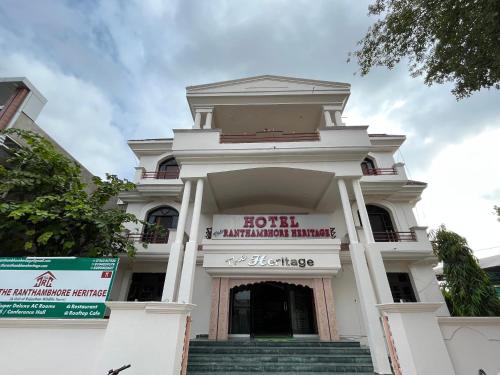 a white building with stairs in front of it at The Ranthambhore Heritage in Sawāi Mādhopur