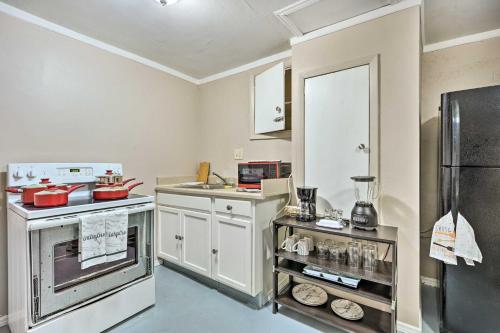 a kitchen with white cabinets and a stainless steel refrigerator at 4 Mi to Beaches Cozy Studio in Port Richey! in Port Richey