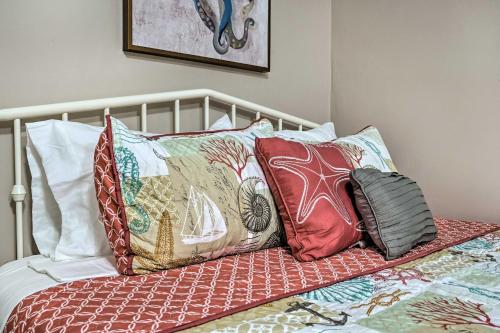 a pile of pillows sitting on a bed at 4 Mi to Beaches Cozy Studio in Port Richey! in Port Richey