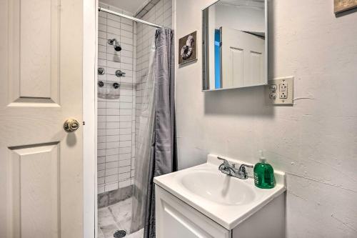 a white bathroom with a sink and a shower at 4 Mi to Beaches Cozy Studio in Port Richey! in Port Richey