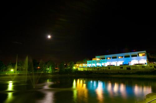 a building at night with a reflection in the water at Villaggio La Pescaccia in San Clemente