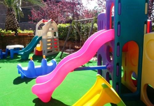 a childrens playground with a slide and a slidesktop at Villaggio La Pescaccia in San Clemente