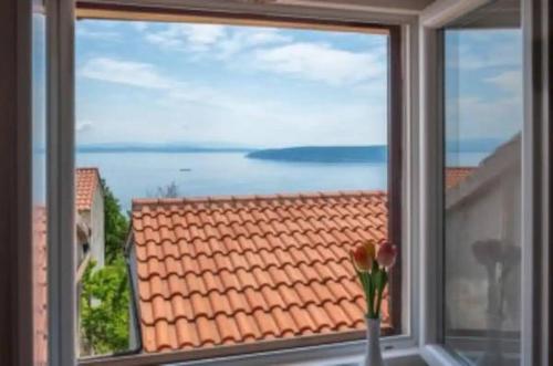 a window with a view of the ocean from a house at House 1 for holidays villagge Obrš,Moščenička Draga,Riviera Opatija in Mošćenička Draga