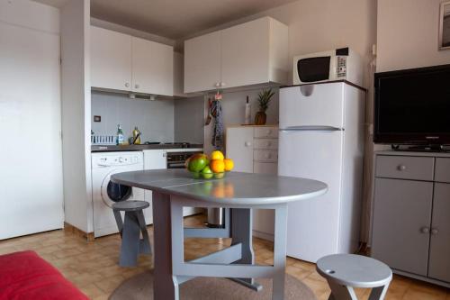 a kitchen with a table with fruit on it at Studio 4 People - Christmas Market - Port - Beach in Le Barcarès