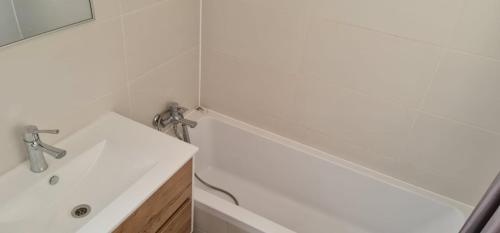 a white bathroom with a sink and a mirror at Nahal Beer sheva נחל באר שבע in Beer Sheva