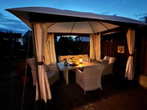 a table with an umbrella on a patio at Ferienwohnung Wolff am Natursteig Sieg und Westerwald in Pracht