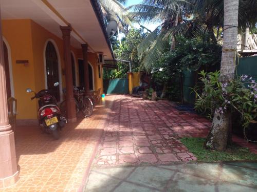 a street with a motorcycle parked next to a building at Grace Villa Bentota in Bentota