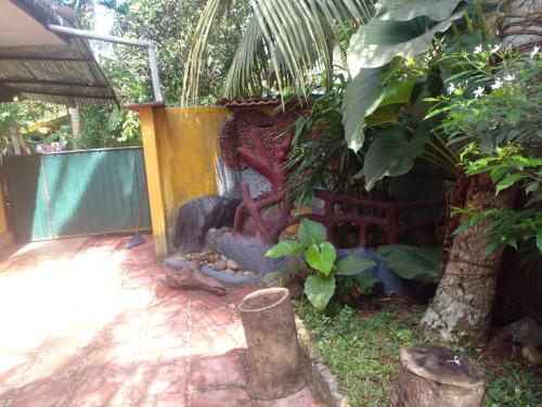 a garden with a stone fireplace in a yard at Grace Villa Bentota in Bentota