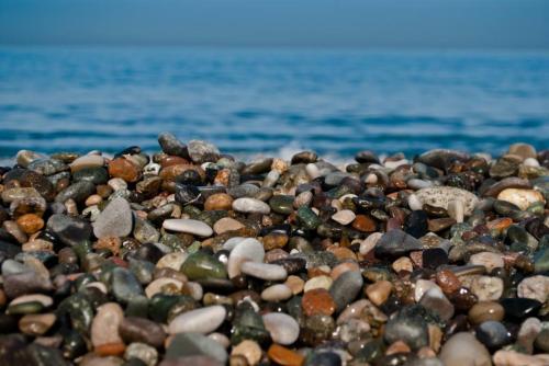 a pile of rocks on a beach near the water at Next Wave Aparthotel in Batumi