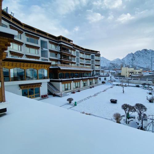 a view of a building with snow on the ground at The Grand Dragon Ladakh in Leh