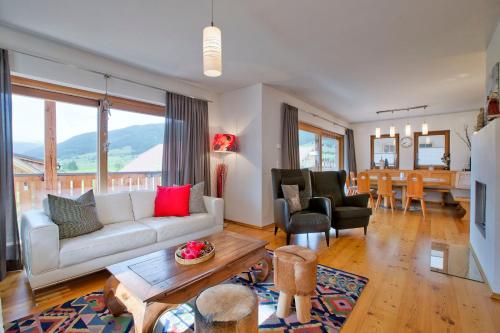 a living room with a couch and a table at Panorama Chalets Mauterndorf in Mauterndorf