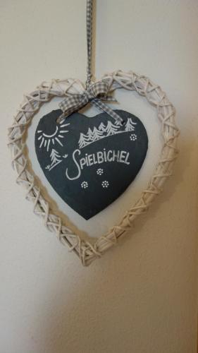 a heart shaped heart ornament hanging on a wall at Marhof Pustertal in Anras