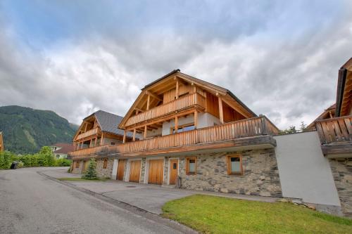 a large house with wooden at Panorama Chalets Mauterndorf in Mauterndorf
