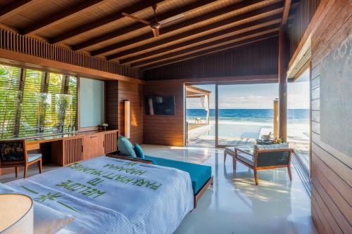 a bedroom with a bed and a view of the ocean at Park Hyatt Maldives Hadahaa in Gaafu Alifu Atoll