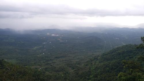 a view of a misty mountain valley with trees at Vista Suites Doddabetta Ooty By Bestinn Leisure in Ooty