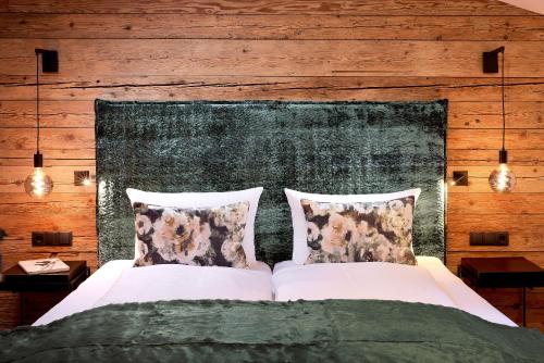 a bedroom with a bed with two pillows at Chalet Gletscherblick in Sankt Anton am Arlberg