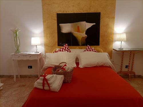 a bedroom with a red bed with a red blanket at B&B Palazzo Armini in Rogliano