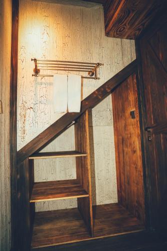 a wooden shelf with towels on a wall at Amaya Retreat in Sóc Sơn