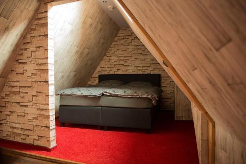a room with a bed in a brick building at Apartment Alma in Quedlinburg