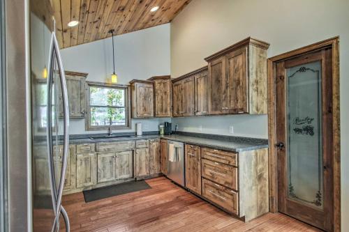 a kitchen with wooden cabinets and a glass shower at Delightful Isle Retreat with Boat Dock and Slip! in Isle
