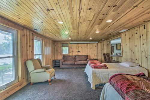 a bedroom with two beds and a couch at Delightful Isle Retreat with Boat Dock and Slip! in Isle