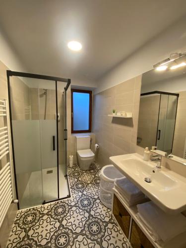 a bathroom with a sink and a toilet and a shower at Aramotz Etxea in Ugarana
