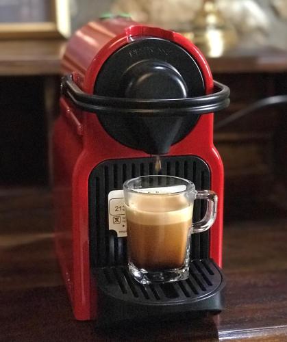 a red coffee maker with a cup of coffee at Oikies Art Rooms in Ángistron