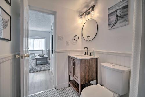 a bathroom with a toilet and a sink and a mirror at Beachfront Studio Apartment with Community Pool in Ventnor City