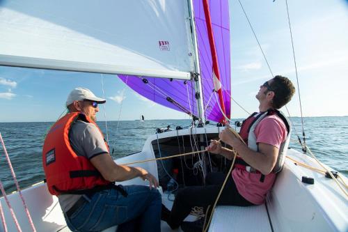 two people on a sail boat in the ocean at Im-Jaich Wasserferienwelt in Lauterbach