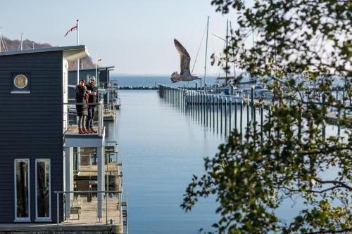 a group of people standing on a dock near the water at Im-Jaich Wasserferienwelt in Lauterbach