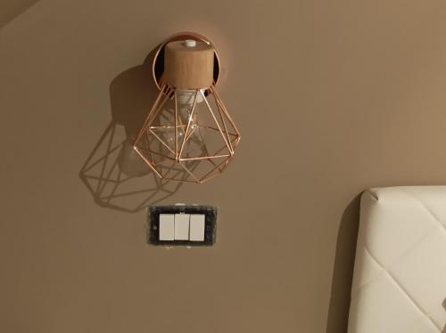 a lamp hanging on a wall next to a couch at Dimora Italia in Campobasso