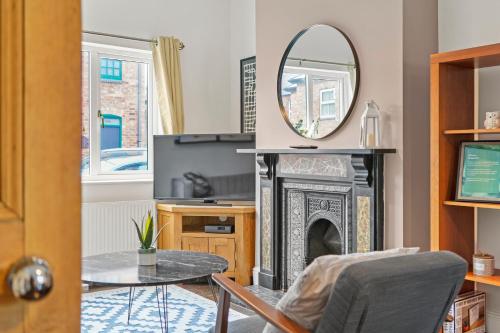 a living room with a fireplace and a mirror at Central House with Pool Table, Free Parking, Super-Fast Wifi and Smart TV with Virgin TV and Netflix by Yoko Property in Northampton