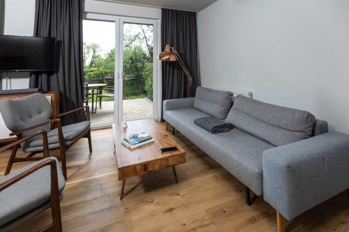 a living room with a couch and a table at Im-Jaich Wasserferienwelt in Lauterbach
