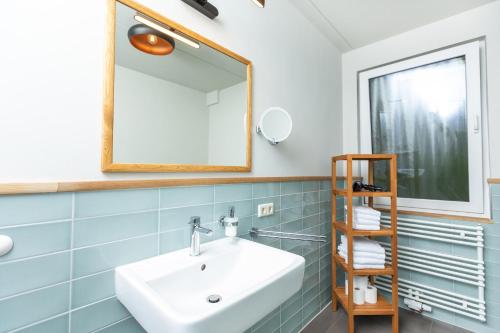 a bathroom with a sink and a mirror at Im-Jaich Wasserferienwelt in Lauterbach