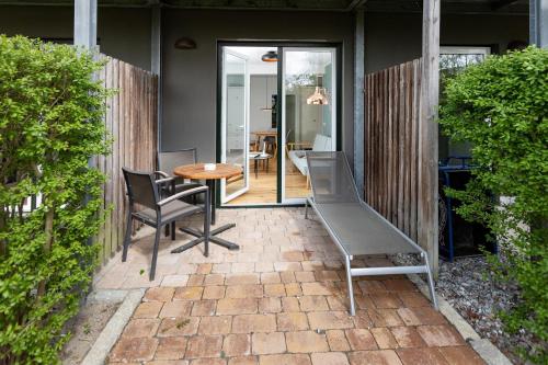 a patio with a table and chairs and a table at Im-Jaich Wasserferienwelt in Lauterbach