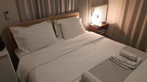 a bedroom with a white bed with a tray on it at Cabo Verde in Agia Triada