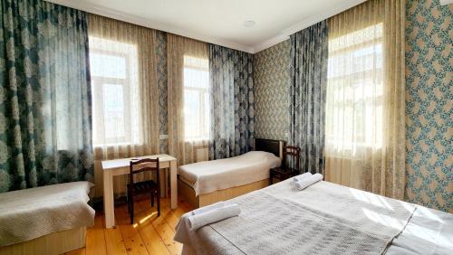 Postel nebo postele na pokoji v ubytování HOTEL JULIA Akhaltsikhe
