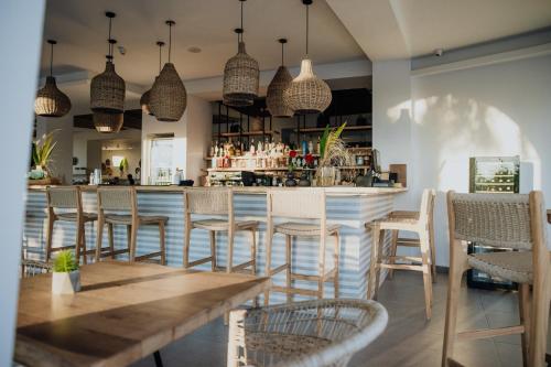 a bar with chairs and a table in a restaurant at Casa Cabana Boutique Hotel & Spa - Adults Only in Faliraki