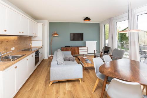 a kitchen and living room with a table and a dining room at Im-Jaich Wasserferienwelt in Lauterbach