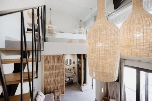 a hallway with two hanging pendant lights in a house at Casa Cabana Boutique Hotel & Spa - Adults Only in Faliraki