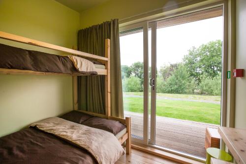 a bedroom with bunk beds and a large window at Tarset Tor Bunkhouse in Hexham