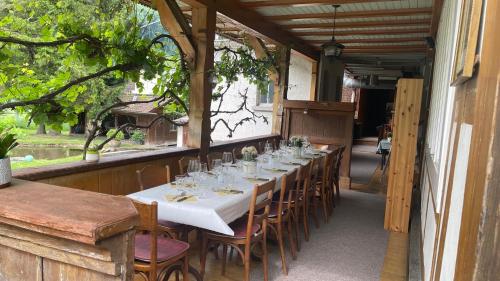 a long table with chairs and wine glasses on it at Hotel Sternen Worb in Worb