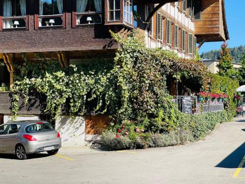 a car parked in a parking lot in front of a building at Hotel Sternen Worb in Worb