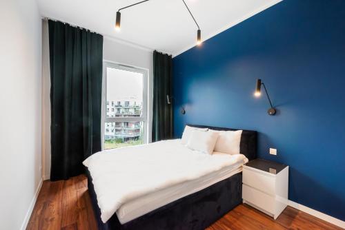Posteľ alebo postele v izbe v ubytovaní Navy Blue Apartment