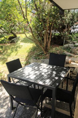 a black table and chairs on a patio at CAYA Bijou im Herzen von Zermatt in Zermatt